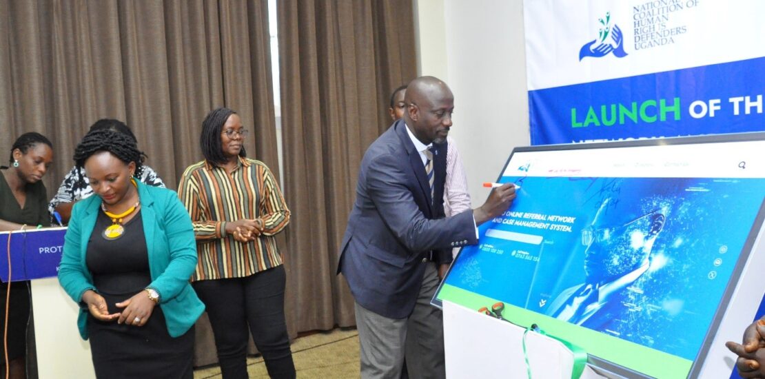 NCHRD-U Executive Director Mr. Robert Kirenga signing on the dummy screen during the launch