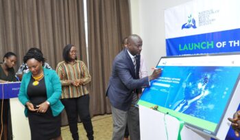 NCHRD-U Executive Director Mr. Robert Kirenga signing on the dummy screen during the launch