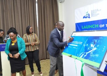 NCHRD-U Executive Director Mr. Robert Kirenga signing on the dummy screen during the launch